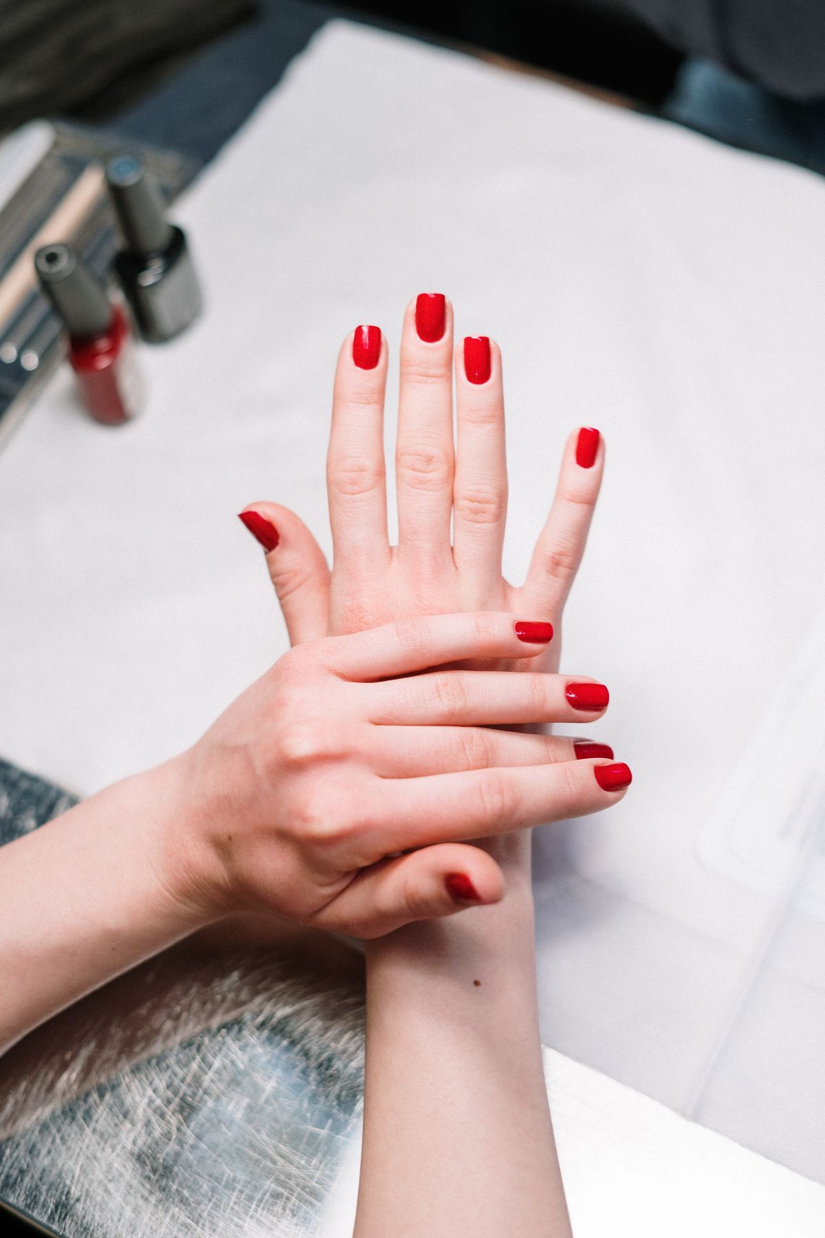 Finished red manicure, hands clasped